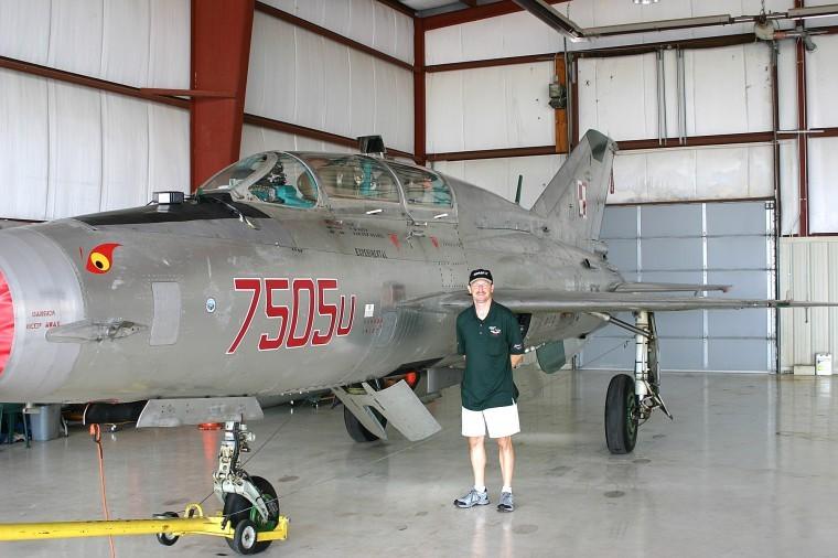 Paul van den Heuvel, of Lake in the Hills, stands next to his Russian-built MiG-21UM Friday at the DeKalb Municipal Airport where the craft is stored.