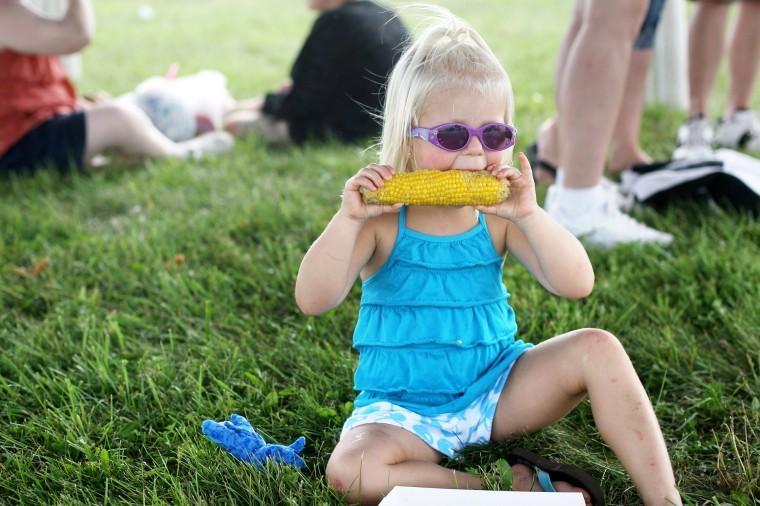 Three-year-old Livi Brennan from Plano enjoys corn on the cob at the annual DeKalb Corn Fest Saturday.