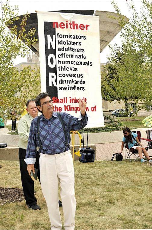 Brother Jed from Campus Ministry of Columbia, Missouri preaches to students and passerbys about the bible and God Monday afternoon at the MLK Commons.