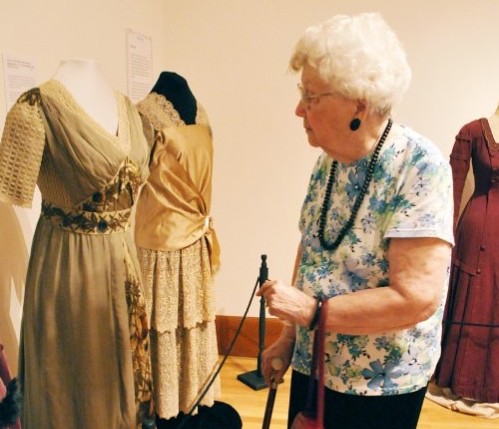 NIU Alum Shirley Johnson, of Maple Park, Ill., views a piece from the exhibit The Autumn Leaves - A Century of Fall Fashion 1900-1999 Wednesday afternoon in the NIU Art Museum at Altgeld Hall.