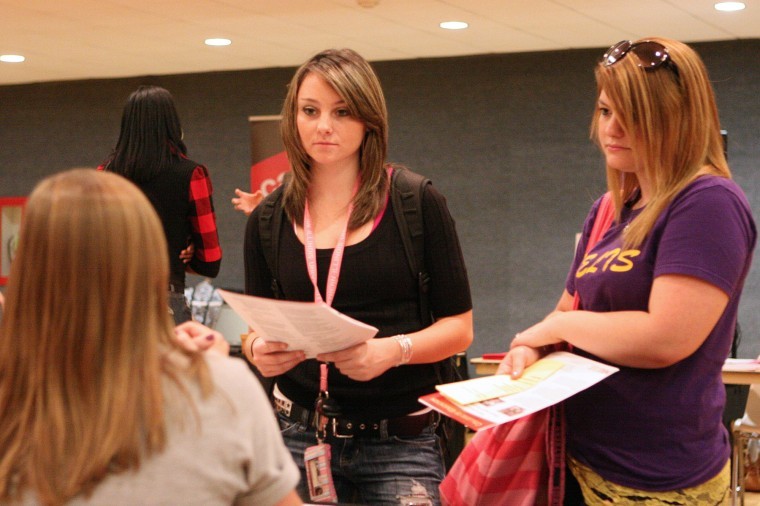 Freshman undeclared majors Jenny Kazy-Garrey (left) and Courtney Fanizza speak with KNPE Academic Advising Graduate Assistant Jessica Brenner during the Exploring Majors Fair Wednesday afternoon in the Duke Ellington Ballroom.