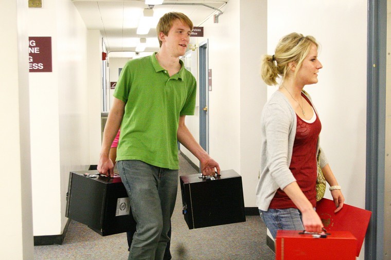 Sam Fuqua, senior computer science major, and Hannah Hornung, sophomore computer science major, take Student Association Senate ballot boxes to be counted in Adams Hall after polls closed  Wednesday evening. Over 1,000 students voted in the election.