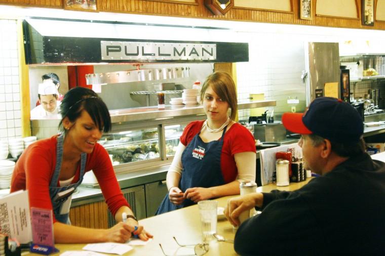 Courtney Levit, left and Sara Grant wait on a regular customer, Mike, at The Junction in this Jan. 31 file photo. The Junction is one local business that has not been affected by recent egg recalls because the company uses locally harvested eggs.