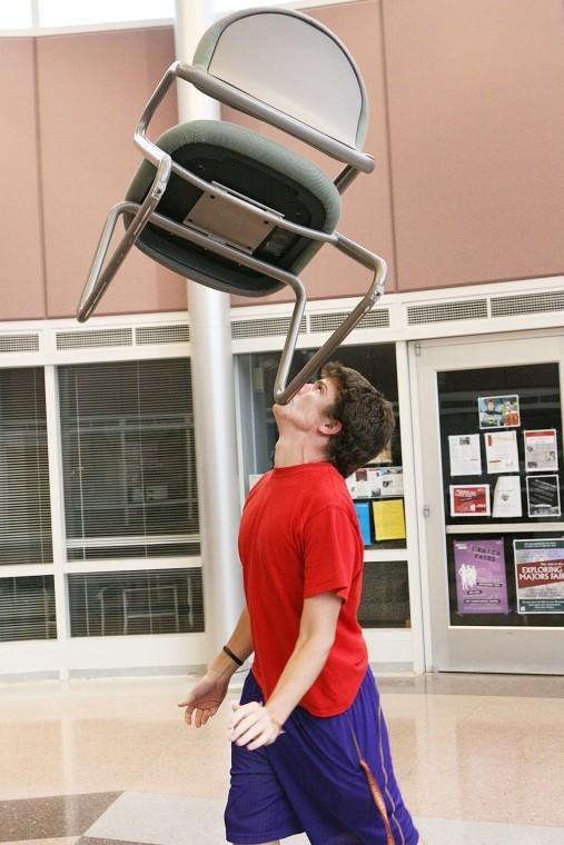 Colin Sullivan, junior physical education major, balances a chair on his chin in the Campus Life Building Thursday evening. Sullivan recently won a nationwide talent show on Live with Regis and Kelly using his talent for balancing items on his chin. 