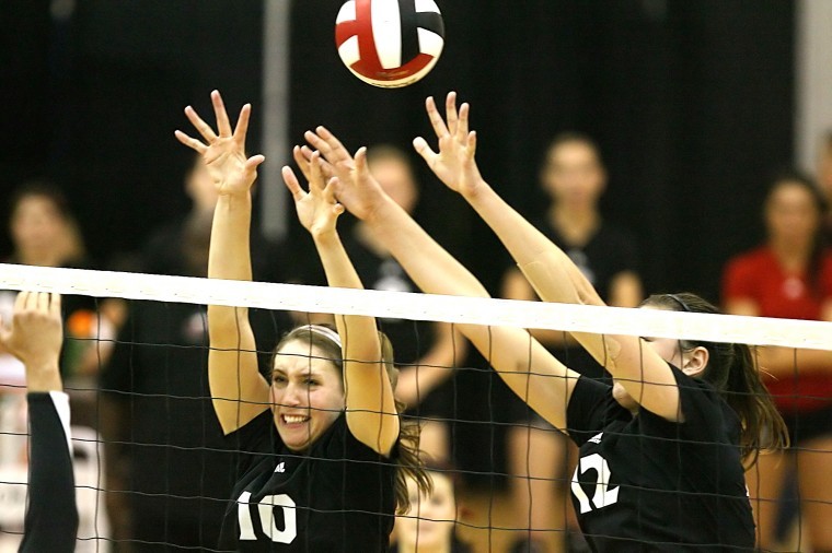 Middle blocker Mary Kurisch (10) and Lauren Wicinski (12) attempt to block an attack against Iowa Sunday afternoon.