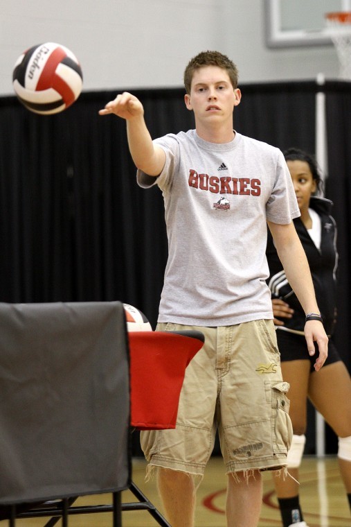 Jared Ridge, NIU volleyball team manager, helps with warm-ups before a match.