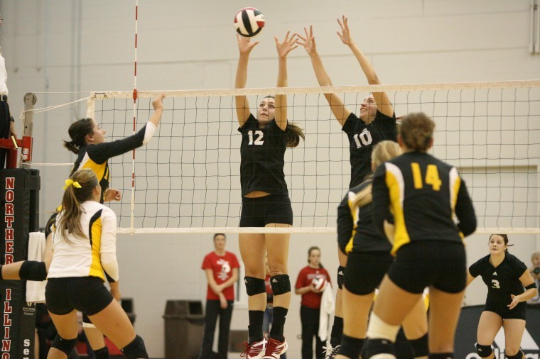 NIUs Lauren Wicinski (12) and Mary Kurish (10) leap for the ball during a home match earlier this season.