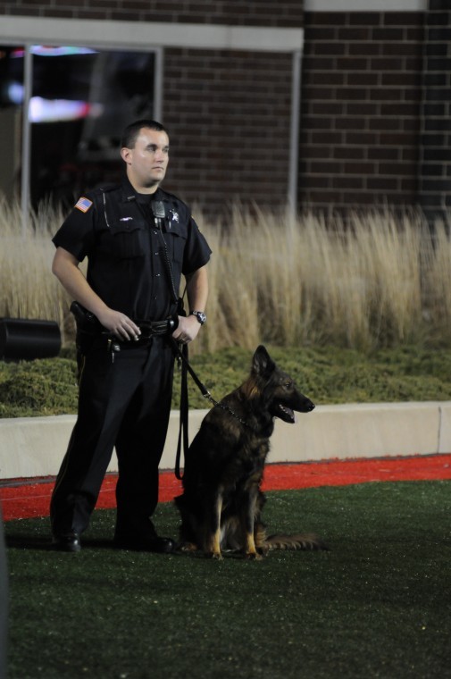 An NIU Police officer stands with Kazan, one of the oldest members of the NIU Police K-9 Unit. 