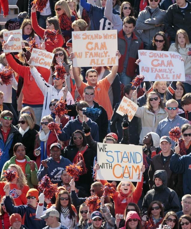 This Nov. 6, 2010 file photo shows Auburn fans showing their sentiments to the Cameron Newton investigation by the NCAA over his recruitment, prior to an NCAA college football game against Chattanooga at Jordan-Hare Stadium in Auburn, Ala. The Auburn Tigers found themselves defending quarterback Cam Newton for the second time in five days, this time adamantly sticking up for the Heisman hopeful in the wake of allegations of academic cheating when he was at Florida.