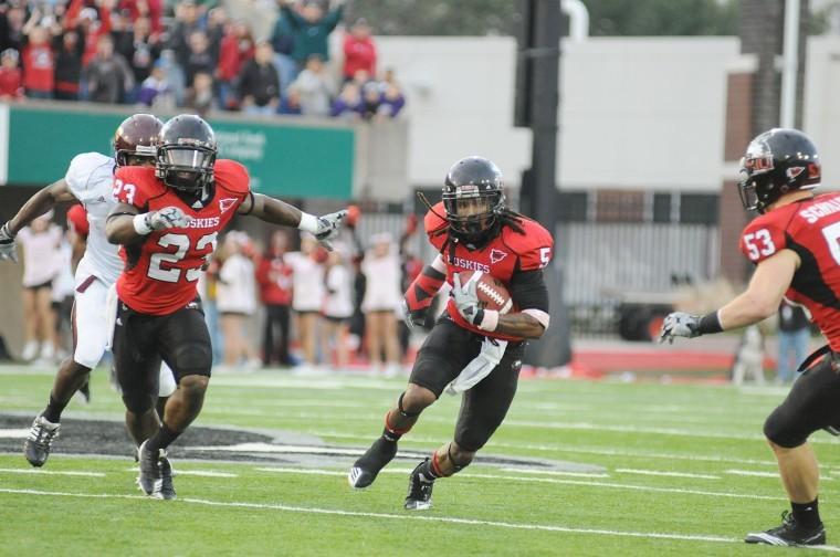 NIU defensive back Chris Smith (middle) has stepped his game up both on the field and in the classroom.