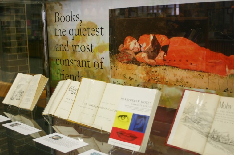 A display case in Founders Memorial Library featuring the favorite books of staffers.