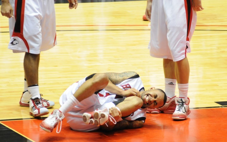 NIUs Xavier Silas grimaces after injuring his ankle in Wednesdays loss to Central Michigan.