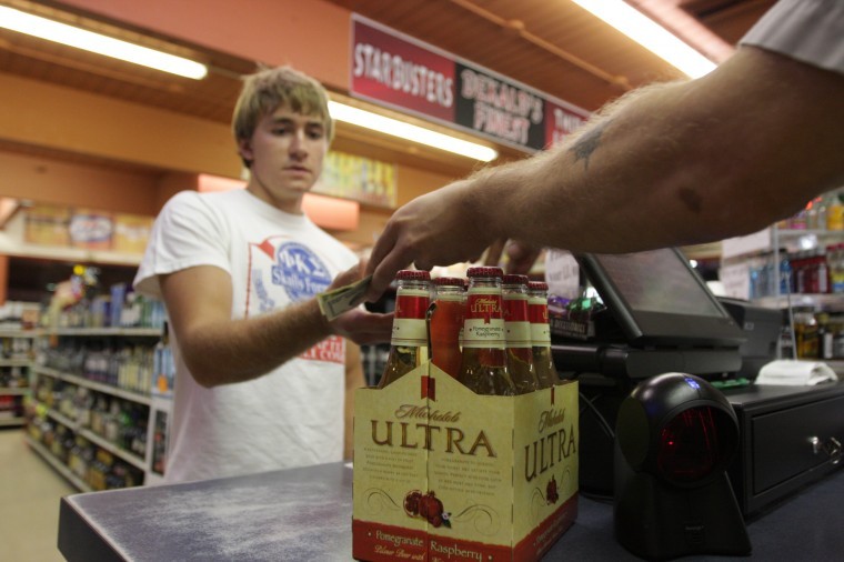 A customer purchases beer at Thirsty Discount Liquors, located at 1039 W. Hillcrest Dr. in DeKalb. Liquor stores saw an increase in customers due to the blizzard that hit the area on Tuesday. 