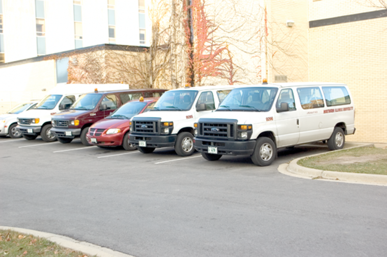 The Late Night Ride vans are parked outside of the NIU Police headquarters. Many people in the community use the free service to go all over the DeKalb area.