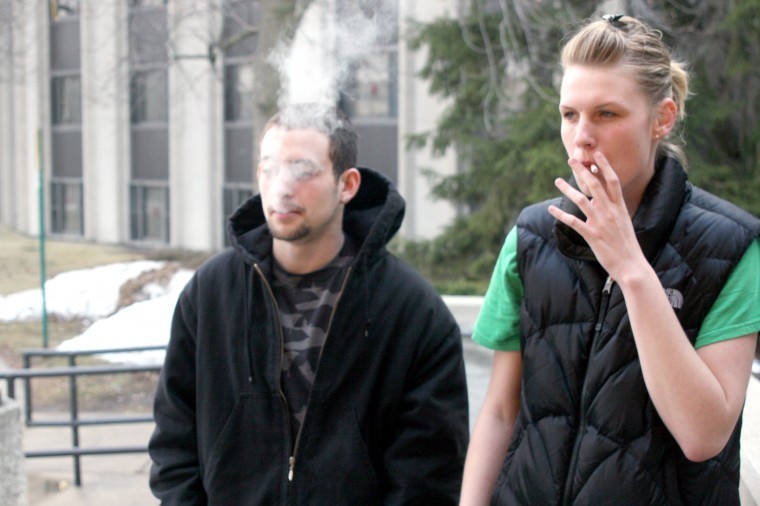Freshman history major Jacquelyn Finnander (right) and freshman mechanical engineering major Eric Forest (left) smoke outside of Douglas Hall. 