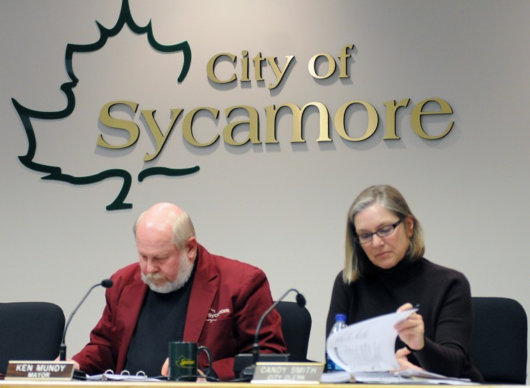 Sycamore Mayor Ken Mundy and City Clerk Candy Smith review the FY2012 budget Wednesday night