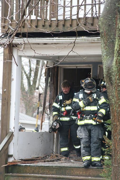 Firefighters leave a house at 414 Prospect St. in DeKalb Tuesday morning after battling a structure fire. 