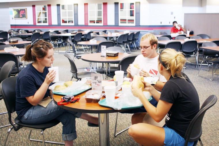 Alicia Artner (left) and Brian Walsh (middle), both junior English majors, and Alexis Paull (right), sophomore psychology major, dine at the Dog Pound Deli in Douglas Hall. 
