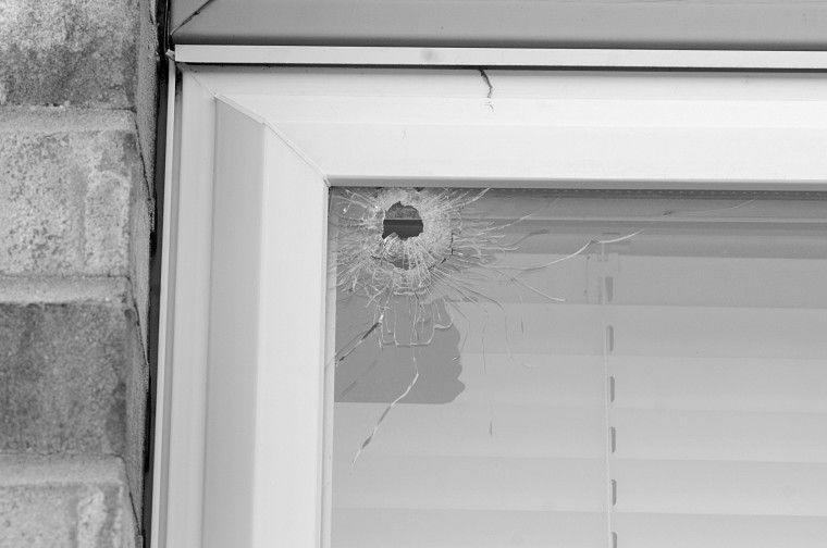 Jerry Burnes | Northern Star
A window at 1009 Aspen Dr. is broken after gunshots were fired at the building Tuesday night. Neighbors confirmed Wednesday that the window was at Apartment 3, the intended target of the gunshots. A bullet penetrated the glass and struck NIU line backer Devon Butler. 