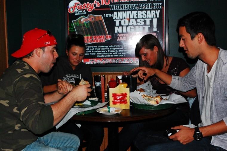 Jake Swanson (far right), Sammi Cain (middle right), Erica Oney (middle left) and Robert De Corah (left) enjoy dinner at Fattys Pub & Grille Thursday night. Fattys is celebrating its 10th anniversary this weekend.