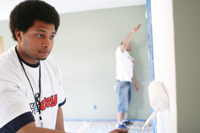 Mike Greene | Northern Star
Freshman sociology major and member of Omega Delta Danny Salazar helps paint the walls of First Church of Nazarene one afternoon as part of a past NIU Cares Day. Salazar and other members of Omega Delta started the day off washing windows at Lincoln Elementary and continued serving the community by painting and landscaping at the church. 