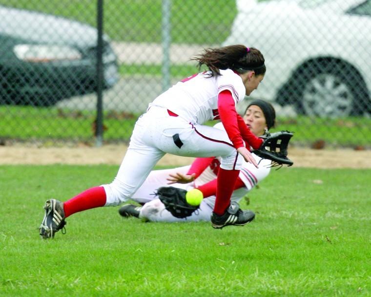 NIU softball players field a ball in the outfield during a game earlier this season.