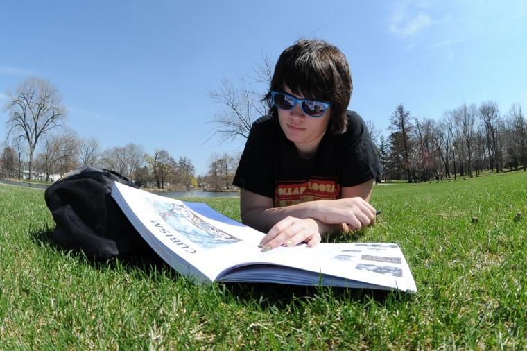 Lauren Nix, sophomore English major, reads an art history book by the East Lagoon on April 12. 