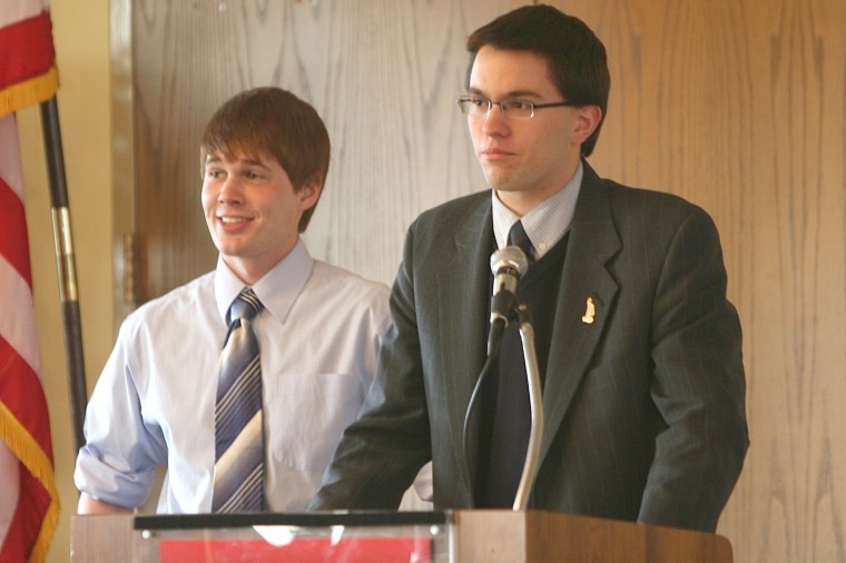 Senators Derek Koegel and Mike Theodore introduce a service project to the Student Association Senate Sunday night. 