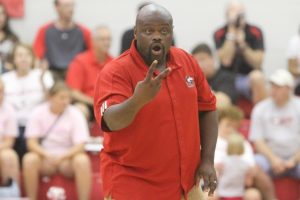 Volleyball coach Ray Gooden works with the team during a match last season.
