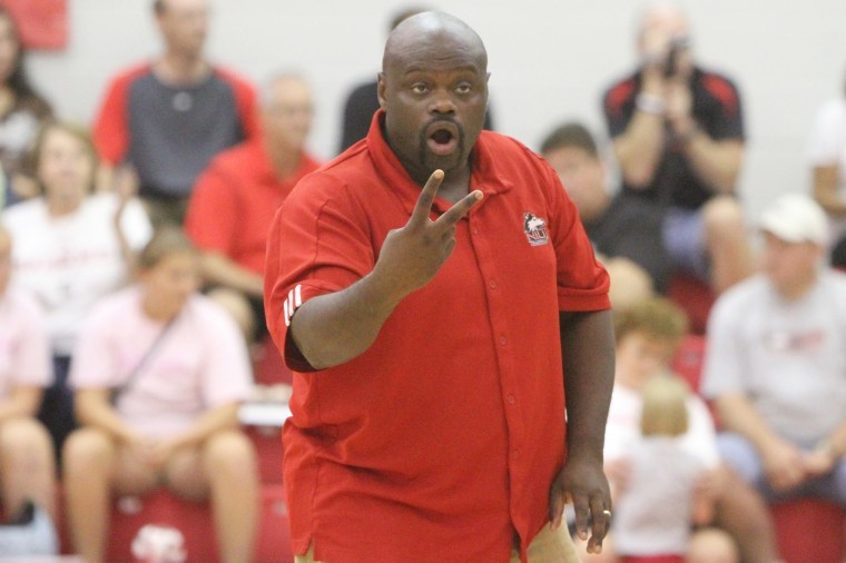 Volleyball coach Ray Gooden works with the team during a match last season.
