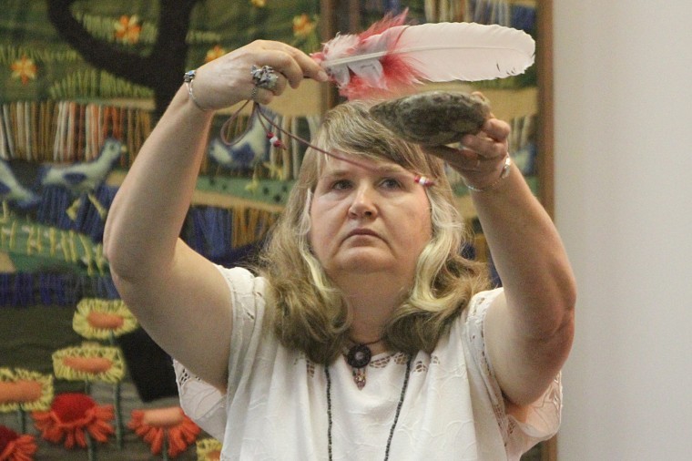 Donna Veeneman performs a Native American ritual Sunday night at
the Unitarian Universalist Fellowship of DeKalb, 158 N.First
Street. The church held a multi-faith gathering called September
11: decade of impact, moment of decision.
