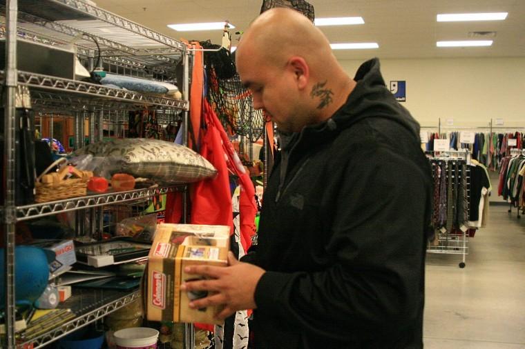 Edgar Degollado, 27, of Chicago looks through items at Goodwill
in DeKalb Thursday night.
