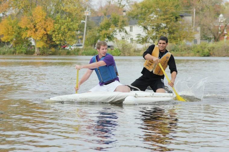 John Motley left, junior actuarial science major, and Jordan
Rush right, sophomore mechanical engineering major, return to
shore to take first place in the Recycled Boat Race at the East
Lagoon Tuesday afternoon.
