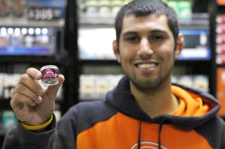 Muhammad Mustafa, owner of Smokers World, 818 W. Lincoln
Highway, holds up a canister of Purple Magic.
