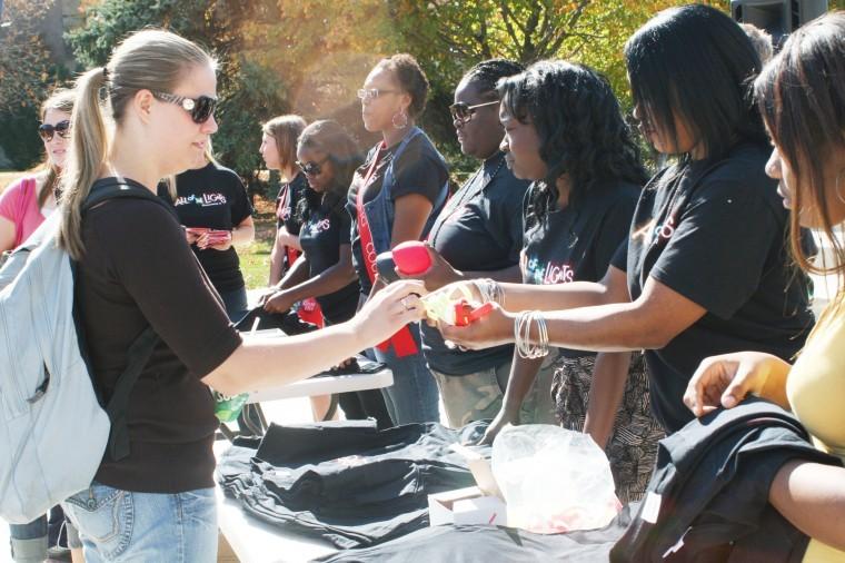 Members of Campus Activities Board hand out Homecoming 2011
T-shirts, footballs and thundersticks during Mondays pep rally in
the MLK Commons.
