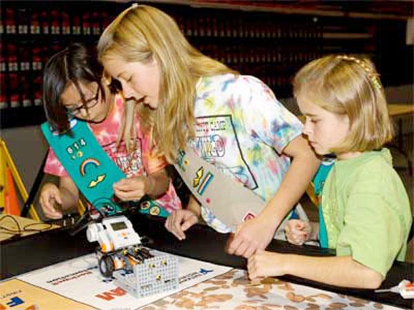 A group of girls explore the technology of a remote control car
at STEMfest 2010.
