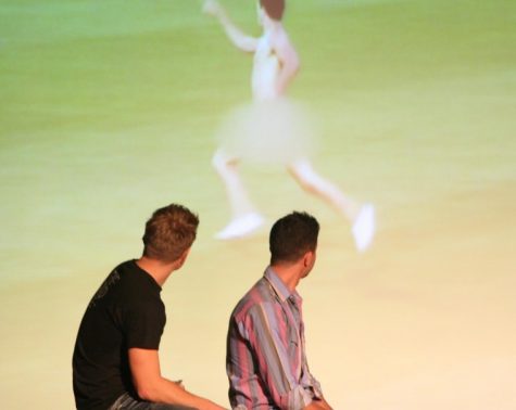Duncan Penn (left) and Ben Nemtin (right) watch a video of
fellow cast member and friend Dave Lingwood run across a soccer
field naked to cross #50, streak a field, off of their bucket list
at the Duke Ellington Ballroom Friday night.