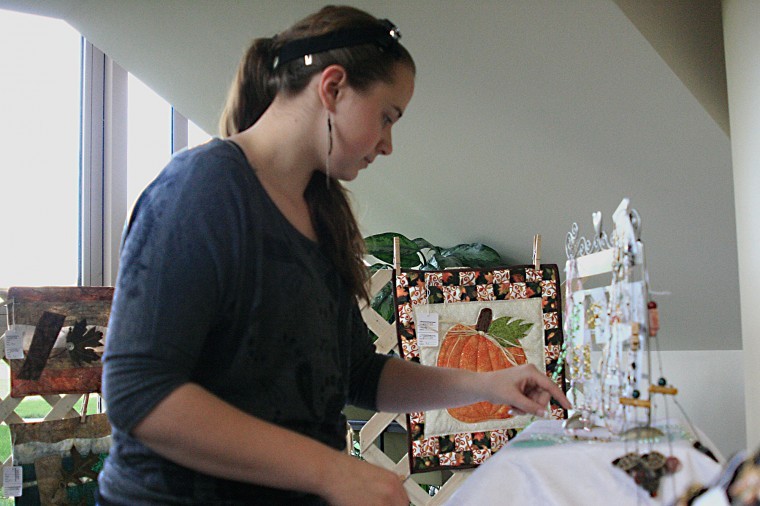 Meghan Connell, Northern Star-Samanatha Schultz, junior
radiology major at Kishwaukee College looks though handcrafted
jewerly at the Second Annual Kish Artisan Market in Kishwaukee
Hospital Friday afternoon.
