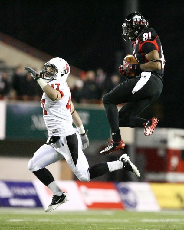 NIUs wide-receiver Nathan Palmer 81 soars through the air
after catching a pass as Ball State linebacker Tony Martin 47
attempted to make a pick during the first half of the match up at
Huskie Stadium on Tuesday night. The Huskies would go on to defeat
Ball State 41-38 making it their sixth straight win.
