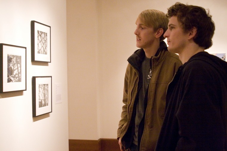 Painting graduate student Bogumil Bronkowski (left) and drawing
graduate student David Willett view artwork in the School of Art
Faculty Art Exhibit at the reception for the three early winter
exhibitions. One exhibition, “The New Art Examiner,” is on display
in the Hall Case Gallery in Altgeld Hall.
