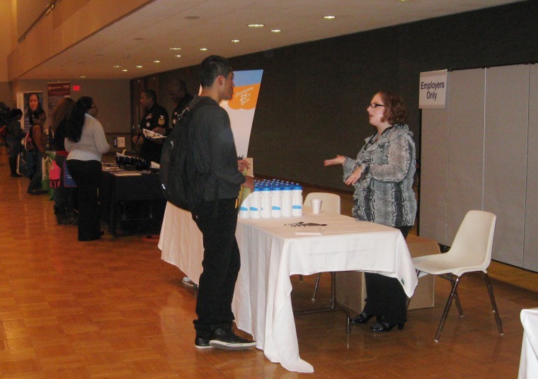 Freshman pre-physical therapy major Esequiel Salas receives
information on occupational therapy jobs from Beth Wilcox, a
representative from Allied Health Professionals LLC at the Heath
Professions Job Fair on Monday.
