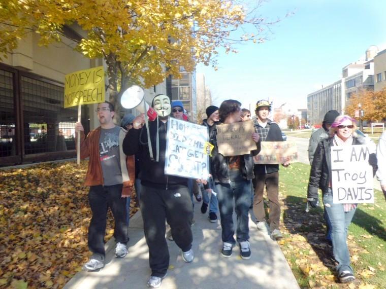 Protesters march together to support Occupy DeKalb and
Wallstreet in MLK commons on Saturday afternoon.
