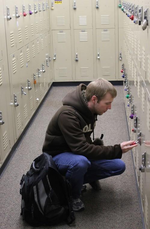 Bill Wojnarowski, second year law student, stops at his locker
after class in Swen Parson hall Tuesday evening.
