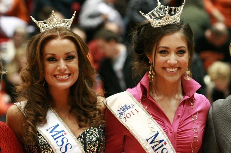 Miss Illinois Hannah Smith (left), and Miss Iowa Jessica Pray
(right), attend the Dekalb versus Sycamore high school basketball
game to help raise money for the Castle Challenge at the
Convocation Center Friday night. Proceeds from the challenge are
used to help booster oragnizations at both of the schools.
