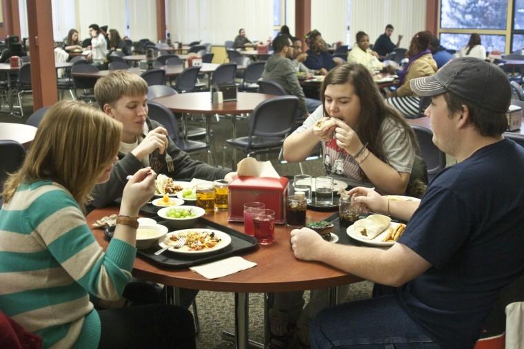From left to right: Aiyana Emsun, sophomore music education
major, senior geology major Will Blair, Sophomore music major
Samantha Raines, and sophomore music major Andrew Voelker eat
dinner in Neptunes all-you-can-eat dining hall in Neptune Central
Monday evening.
