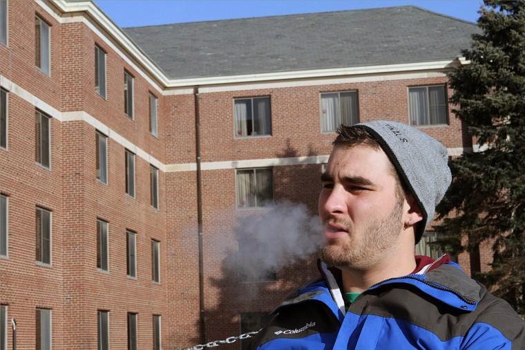 James McClanahan, freshman music performance major, smokes a
cigarette outside of Neptune North Wednesday afternoon.

