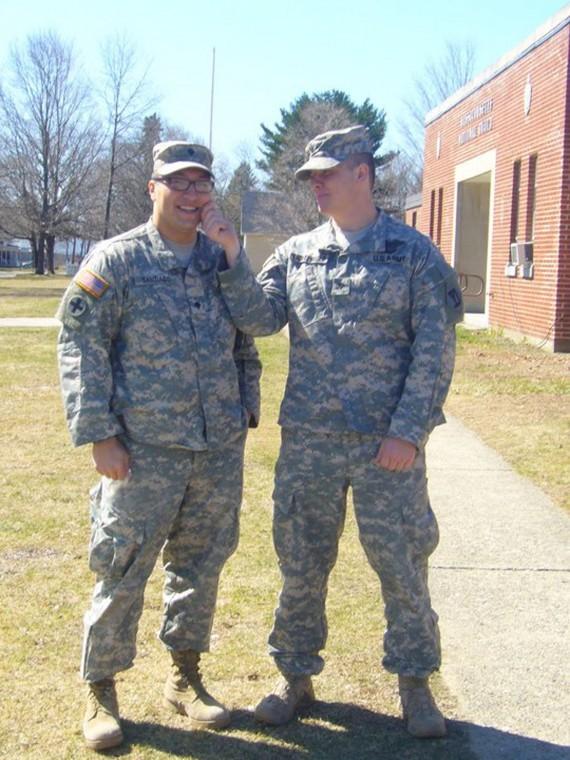Roberto Santiago (left) and Adam Lichtenauer (right) pose for a photo in their uniforms.
