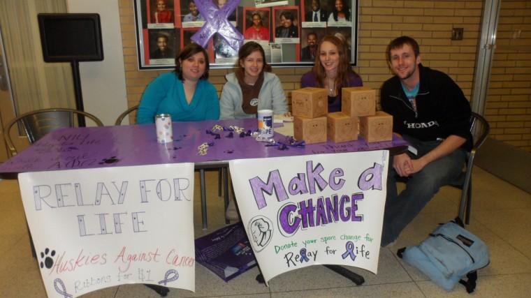 Members of co-ed service fraternity Alpha Pi Omega shout
provocative phrases to attract students during a bake sale
Thursday. The group is raising money for Relay For Life.
