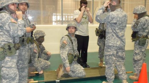 Cadets simulate being blinded by a grenade and then directed
around orange cones by the soldier on the carrier.
