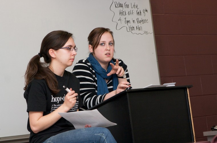 Northern Star Heather Olson (left), and Brittney Ginter, members
of Colleges Against Cancer, lead the clubs meeting Tuesday
night.
